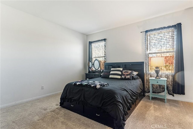 bedroom with carpet floors and multiple windows