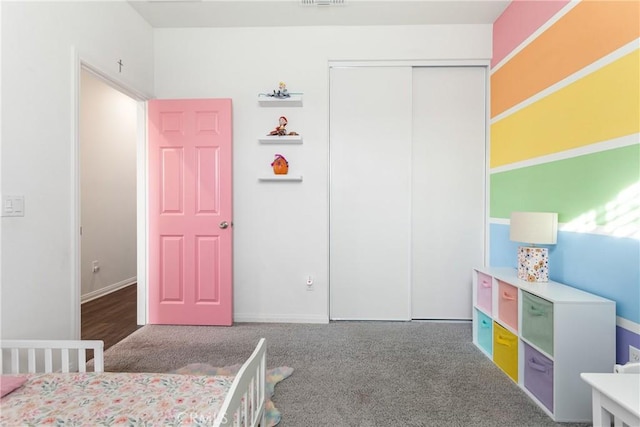 bedroom with carpet and a closet