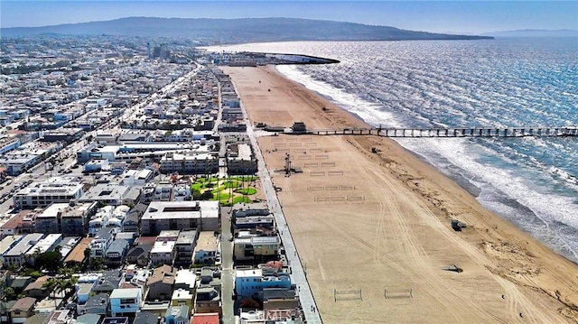 aerial view featuring a view of the beach and a water and mountain view