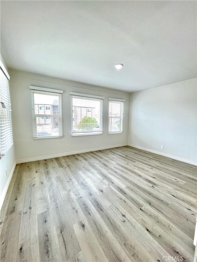 unfurnished room with light wood-type flooring