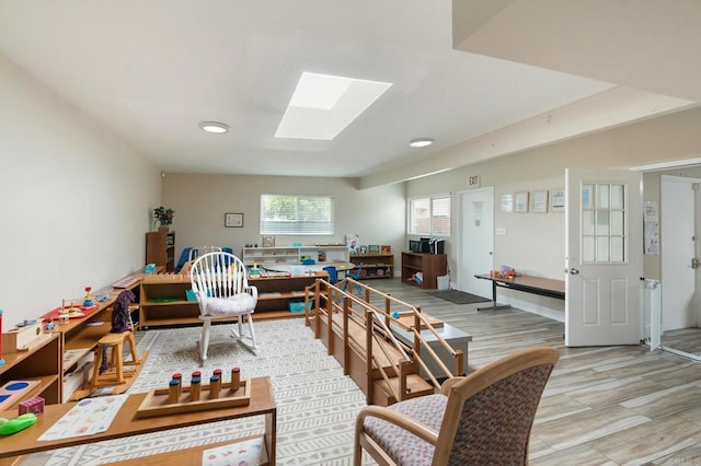 interior space with light hardwood / wood-style flooring and a skylight