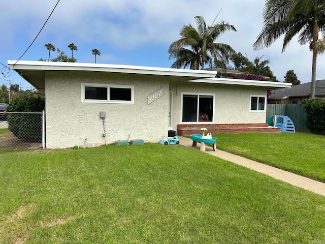 back of house featuring a yard