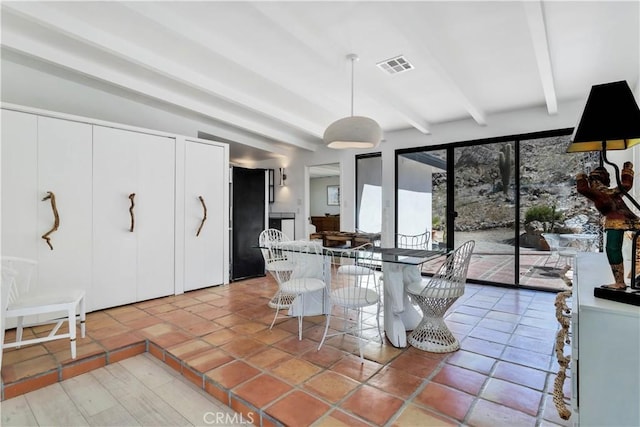 dining area featuring visible vents, beamed ceiling, and light tile patterned floors