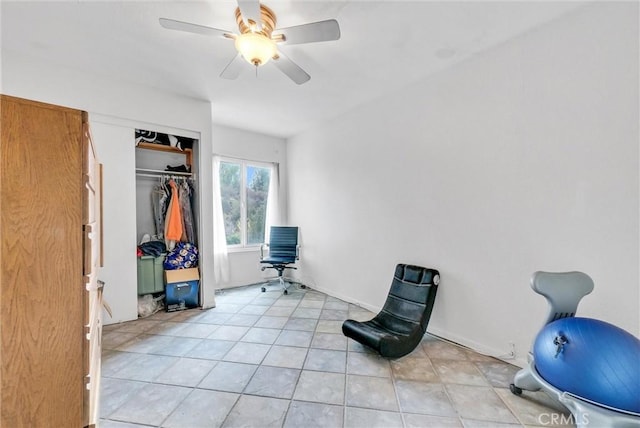 interior space featuring ceiling fan and a closet