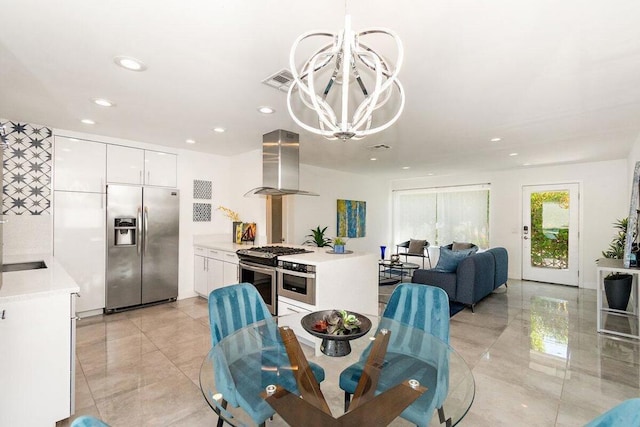 dining room with sink and a chandelier