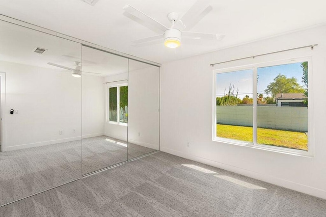 unfurnished bedroom with a closet, ceiling fan, and carpet floors