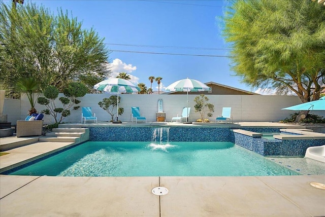 view of pool with pool water feature, an in ground hot tub, and a patio area