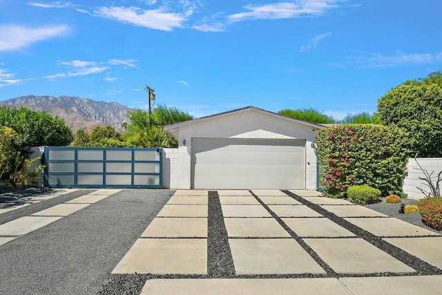 view of front of house featuring a garage and a mountain view