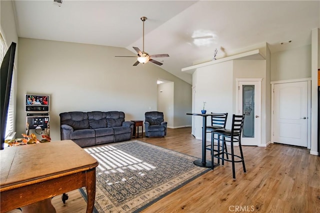 living room featuring ceiling fan, hardwood / wood-style floors, and lofted ceiling