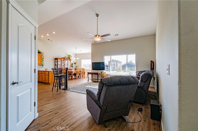 living room with light wood-type flooring and ceiling fan