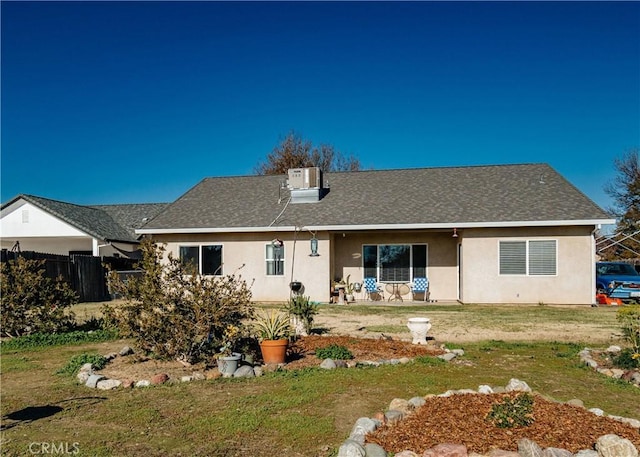 back of house with a lawn