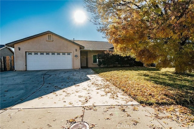 single story home featuring a front lawn and a garage