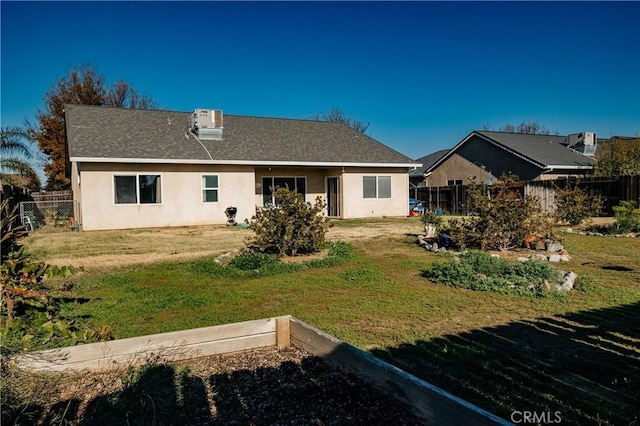 rear view of house with a lawn