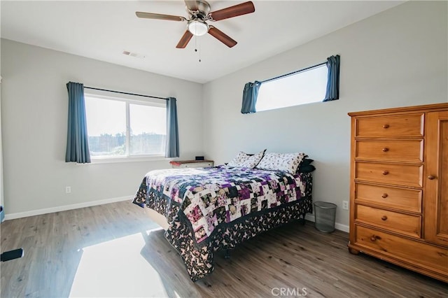 bedroom with dark hardwood / wood-style flooring and ceiling fan