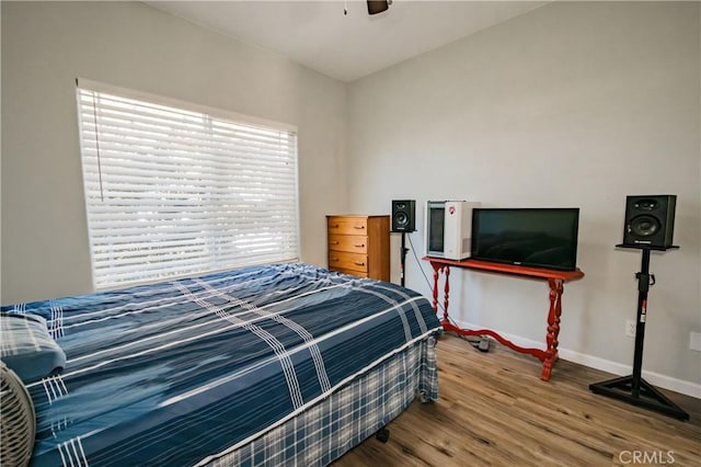 bedroom with wood-type flooring and ceiling fan