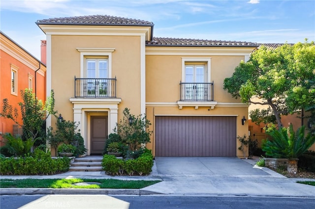 mediterranean / spanish-style house with a garage and a balcony