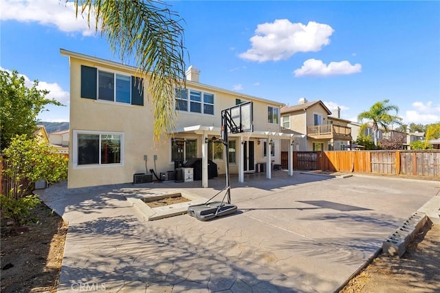 rear view of property featuring a patio area