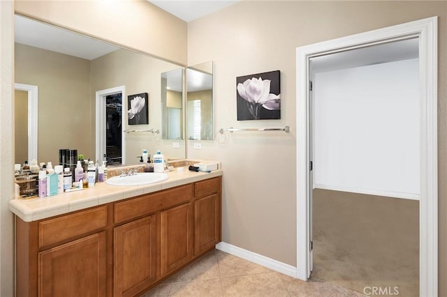 bathroom with tile patterned floors and vanity