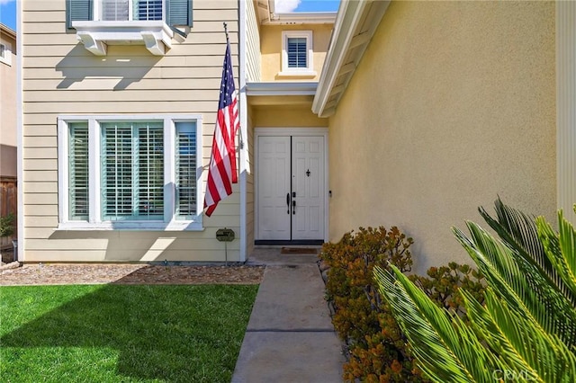 doorway to property with a yard