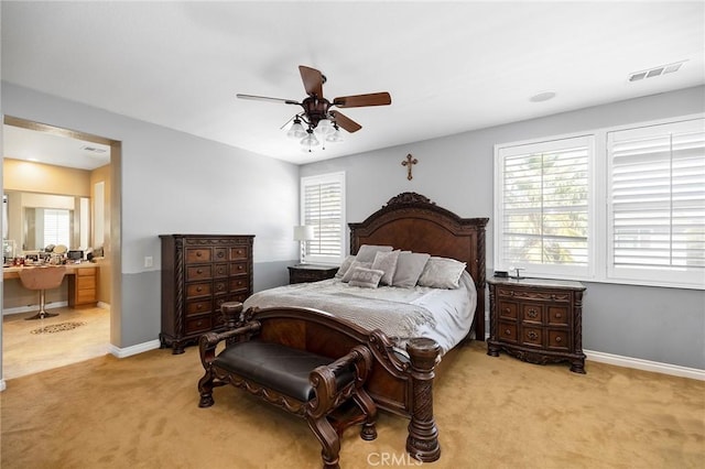 carpeted bedroom featuring ceiling fan and multiple windows