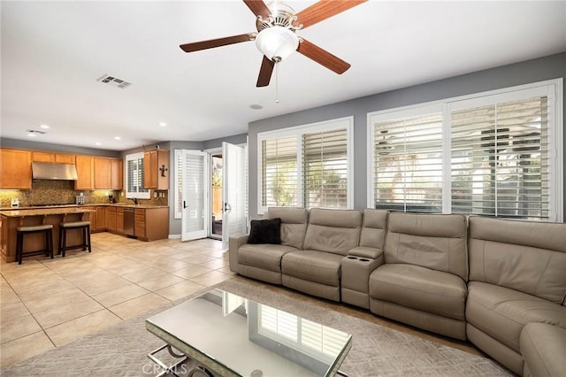 tiled living room featuring ceiling fan