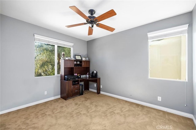 office space with light carpet and ceiling fan