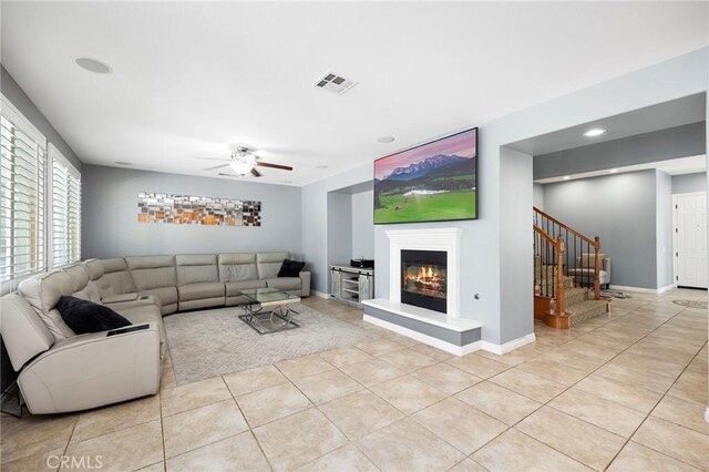 tiled living room featuring ceiling fan