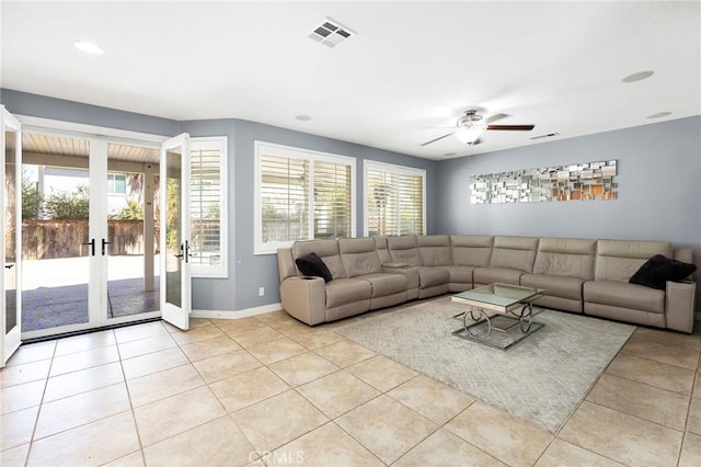 living room with ceiling fan, light tile patterned floors, and french doors