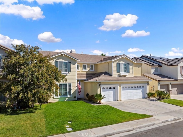 view of property featuring a front lawn and a garage