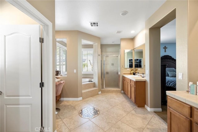 bathroom featuring shower with separate bathtub, tile patterned floors, and vanity