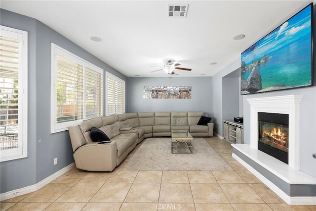 tiled living room with ceiling fan