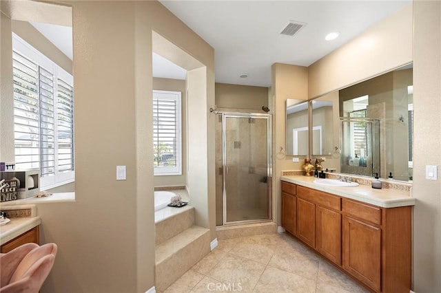 bathroom with tile patterned flooring, separate shower and tub, and vanity