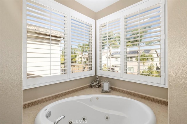 bathroom with a wealth of natural light and a relaxing tiled tub