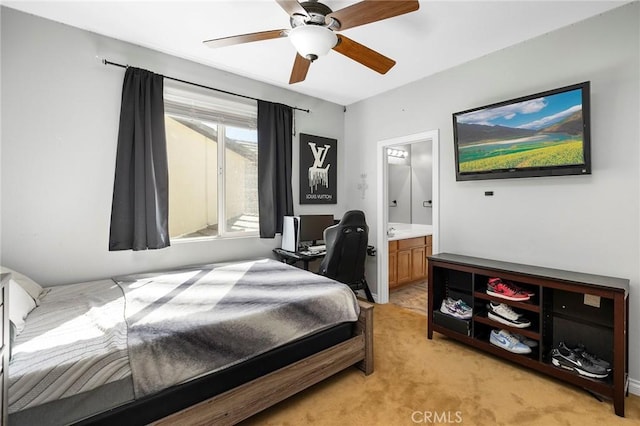 carpeted bedroom with ceiling fan and ensuite bathroom