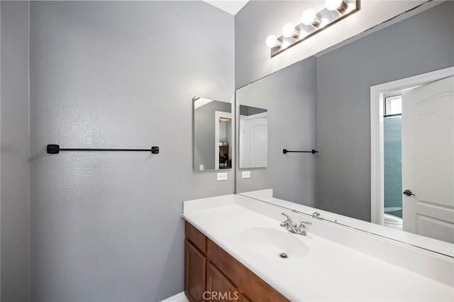 bathroom featuring toilet and vanity