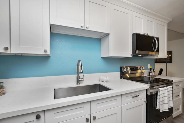 kitchen featuring white cabinetry, sink, and stainless steel appliances