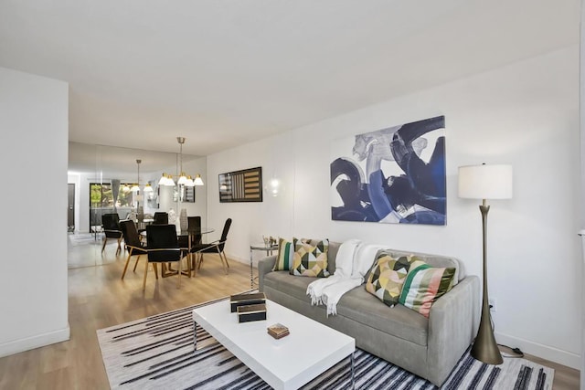 living room featuring a notable chandelier and wood-type flooring