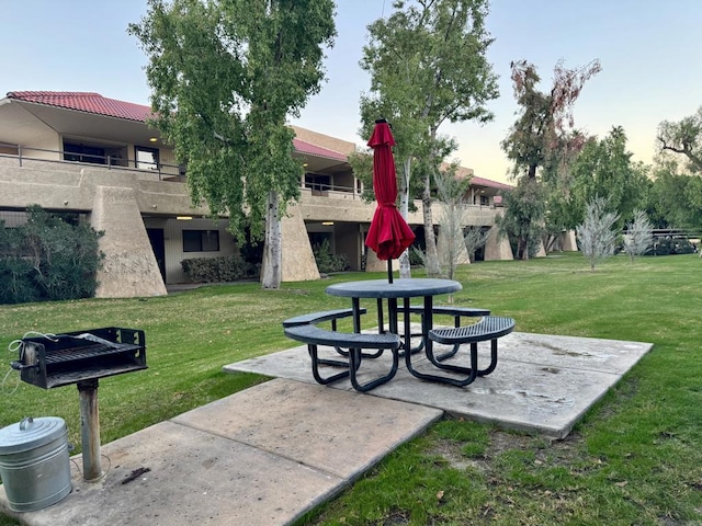 view of community with a patio area and a lawn