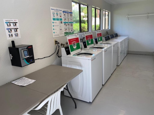 clothes washing area with washer and clothes dryer