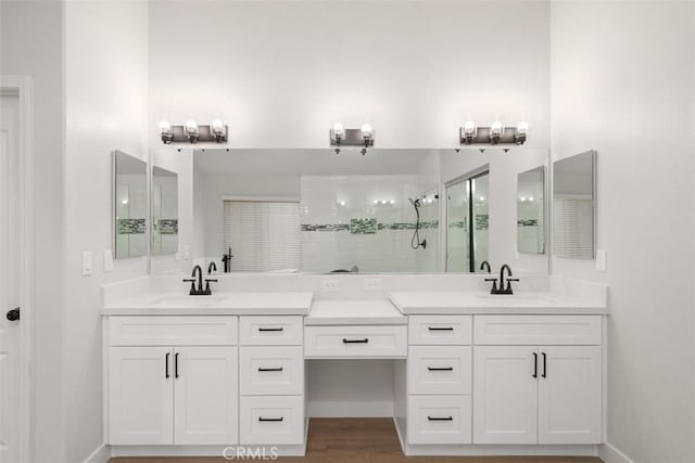 bathroom with wood-type flooring, walk in shower, and vanity