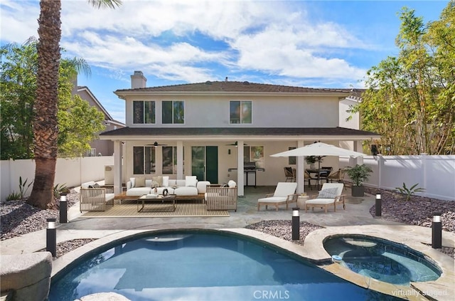 back of house featuring a swimming pool with hot tub, a patio area, ceiling fan, and an outdoor hangout area