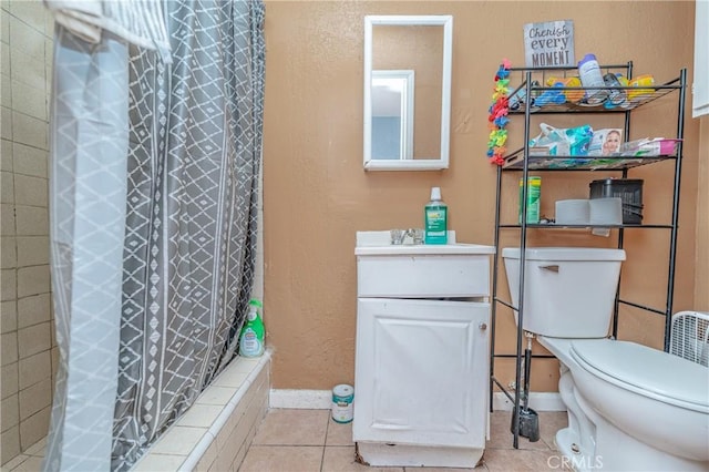 bathroom featuring tile patterned floors, toilet, vanity, and walk in shower