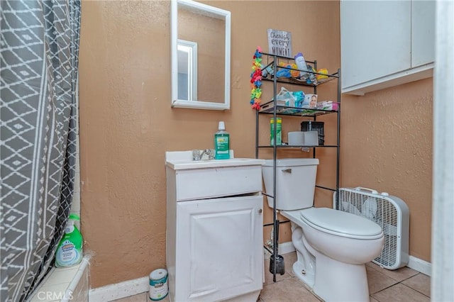 bathroom featuring tile patterned flooring, vanity, a shower with shower curtain, and toilet