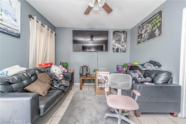 living room with ceiling fan and light tile patterned floors