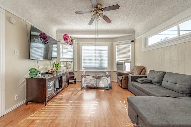 living room with hardwood / wood-style floors, a textured ceiling, ceiling fan, and cooling unit