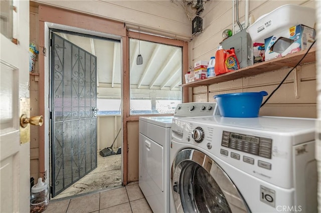 laundry room with light tile patterned floors and washing machine and dryer