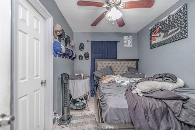 tiled bedroom featuring ceiling fan