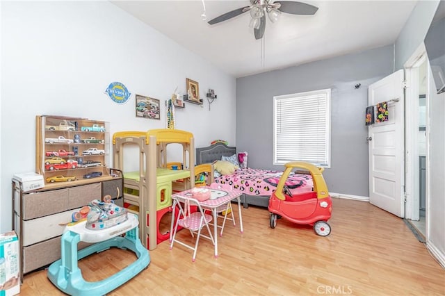 rec room with ceiling fan and light wood-type flooring