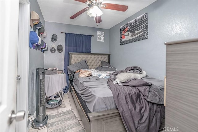 bedroom with ceiling fan and light tile patterned floors