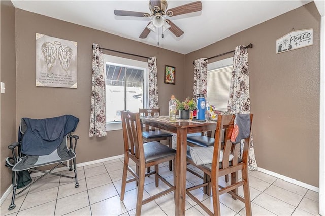 tiled dining area featuring ceiling fan